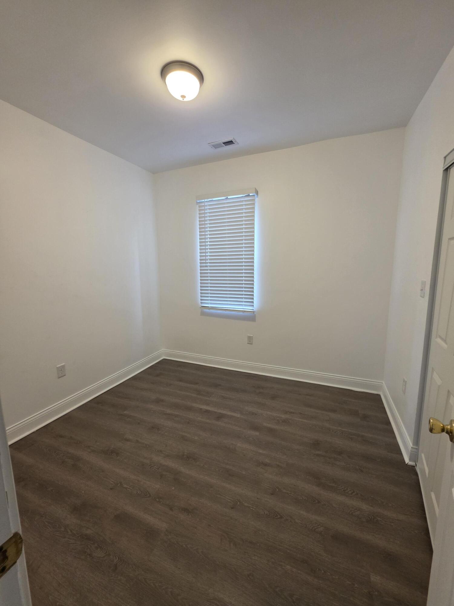 4149 Broadway Gary, IN 46409 - Photo 14 of 26 an empty room with wooden floor and windows
