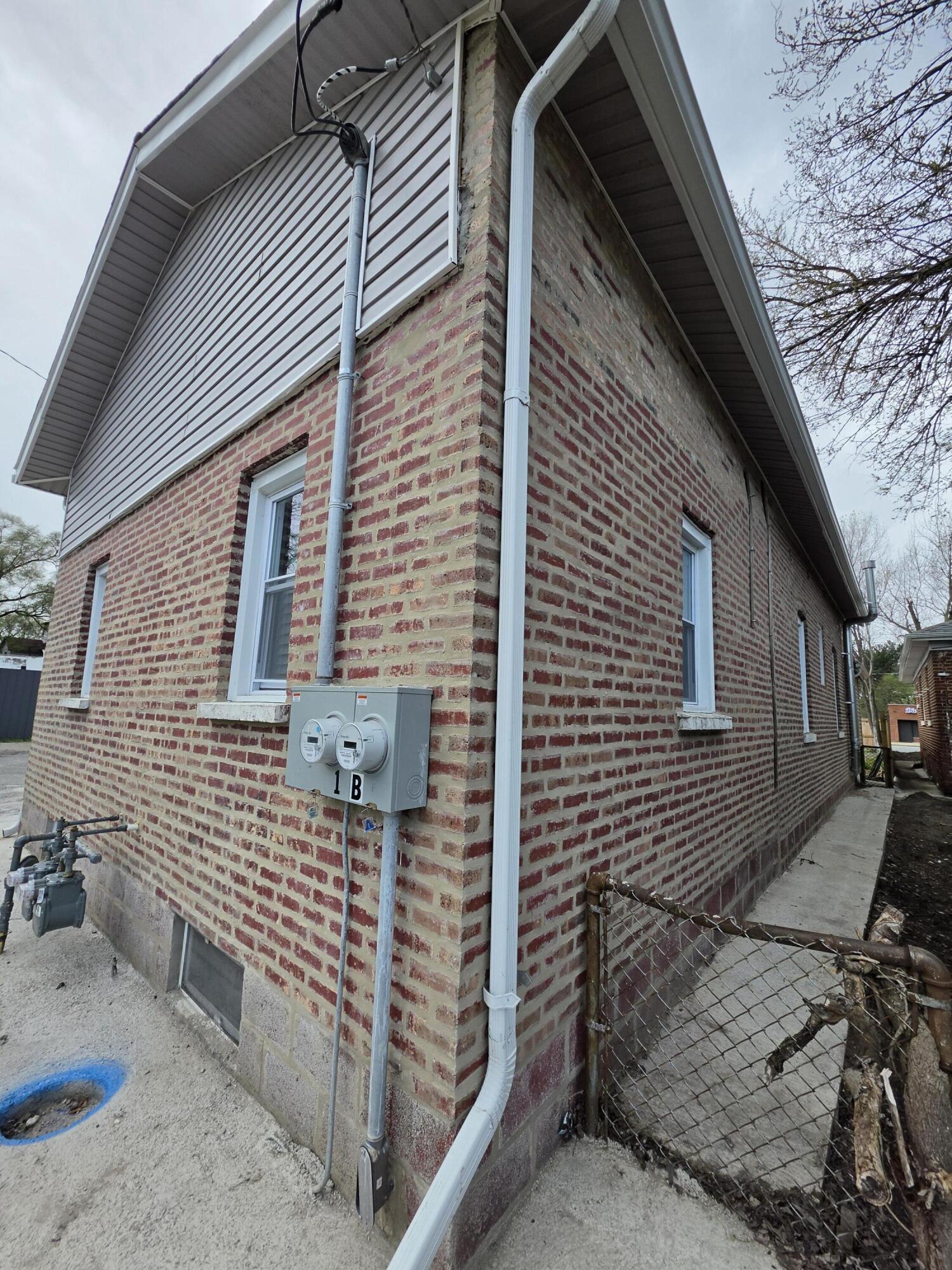 4149 Broadway Gary, IN 46409 - Photo 5 of 26 a view of a brick house with wooden fence