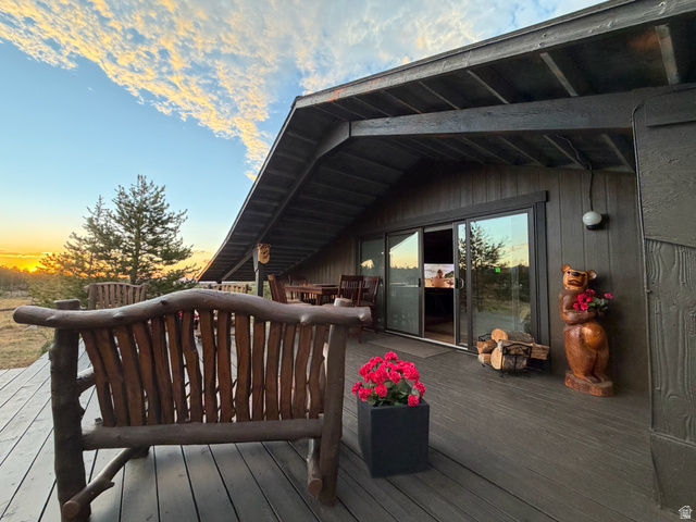 1663 Lancer Lane Evanston, UT 82930 - Photo 2 of 101 Expansive outdoor deck with a rustic wooden bench
