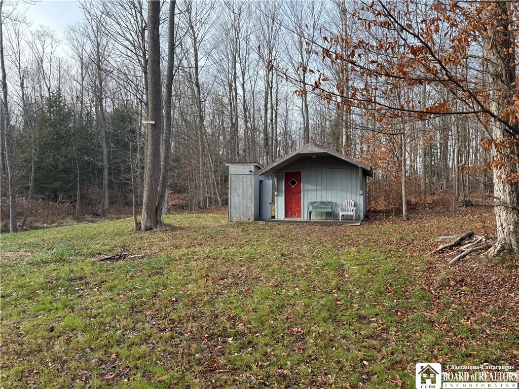 6982 Curriers Road Arcade, NY 14009 - Photo 14 of 47 Cabin and outhouse by pond