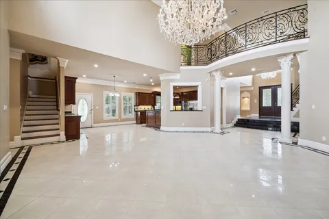 a view of a hallway with a chandelier and livingroom view