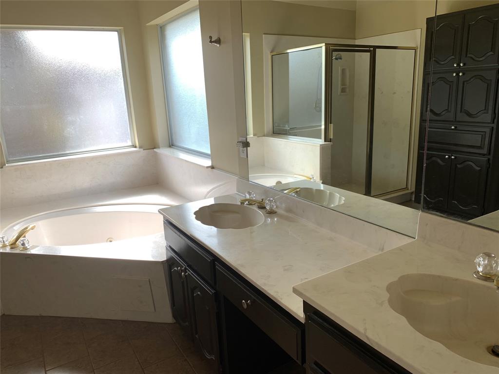 4914 Shadowood Road Colleyville, TX 76034 - Photo 12 of 28 Bathroom with double vanity, a whirlpool tub, a stall shower, and tile patterned flooring