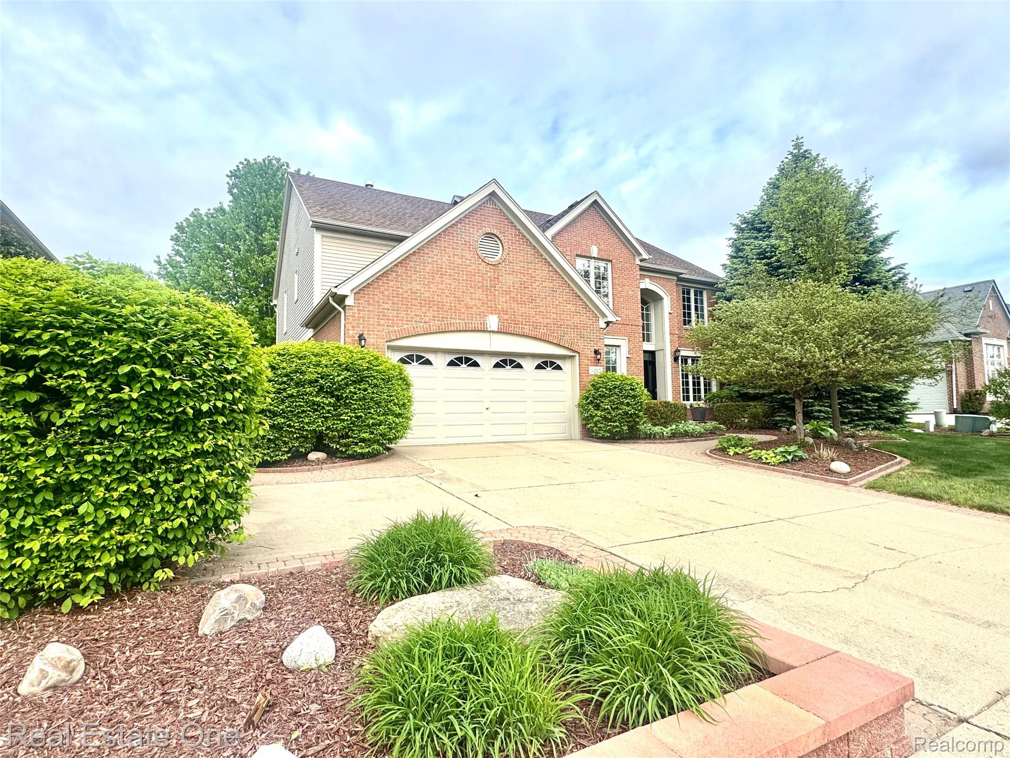 1215 Letica Drive Rochester, MI 48307 - Photo 1 of 43 Traditional-style house featuring concrete driveway, a garage, and brick siding