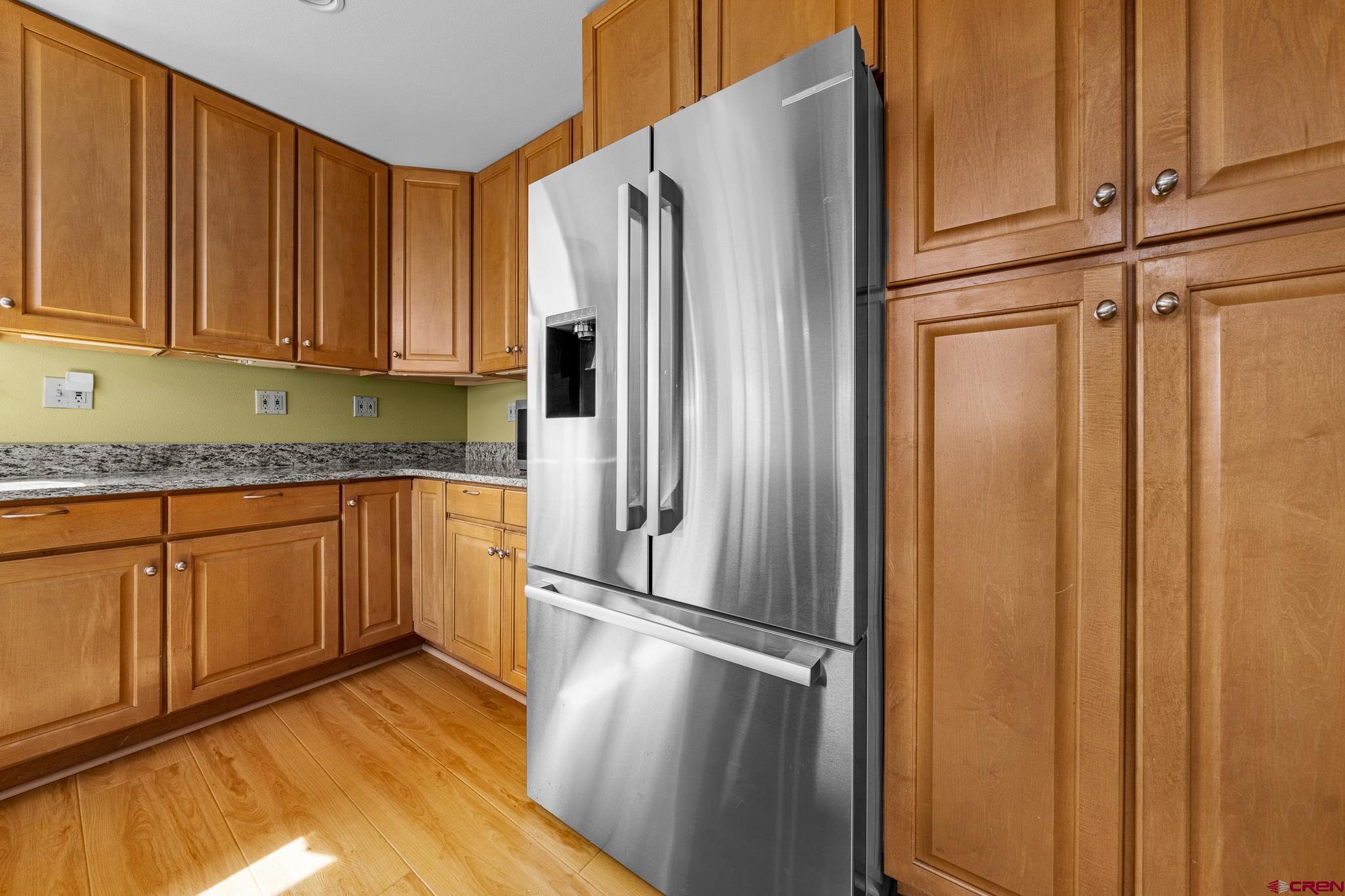 199 Logging Trail Road Durango, CO 81303 - Photo 14 of 33 a kitchen with granite countertop stainless steel appliances a refrigerator and cabinets