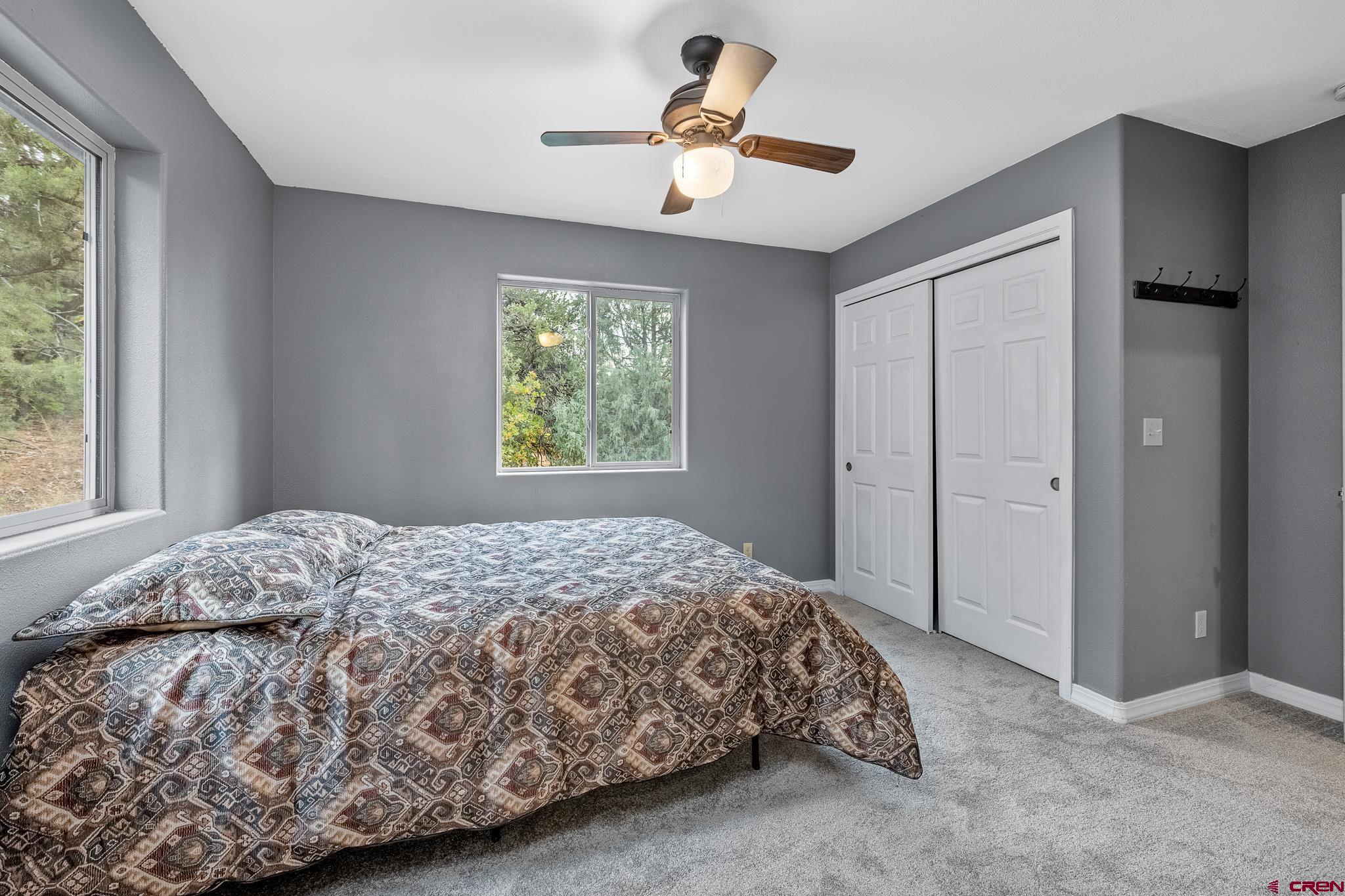 199 Logging Trail Road Durango, CO 81303 - Photo 15 of 33 a bedroom with a bed and a window
