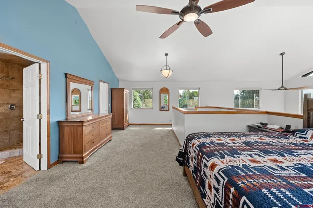 a bedroom with a bed and ceiling fan