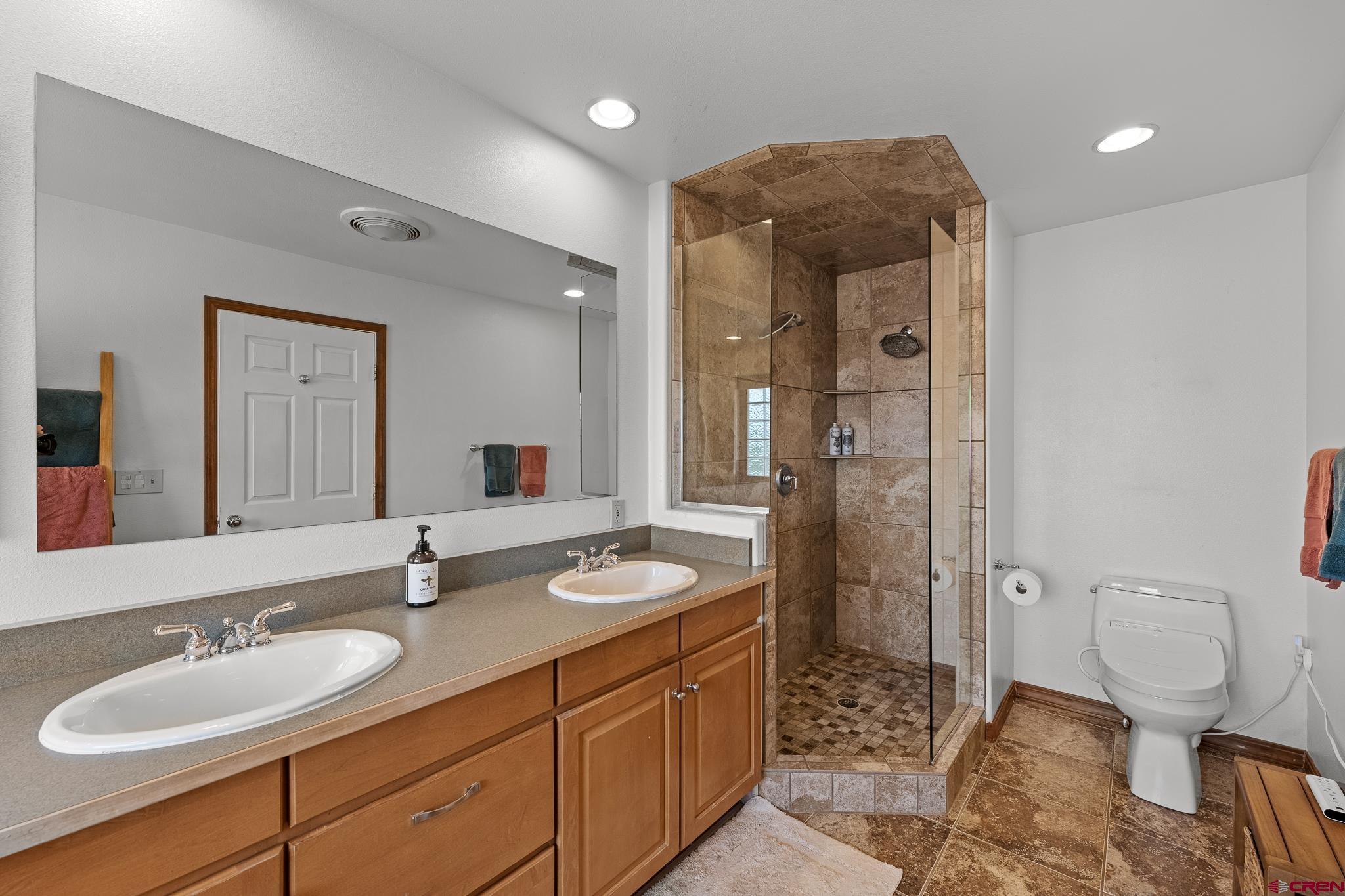 199 Logging Trail Road Durango, CO 81303 - Photo 21 of 33 a bathroom with a double vanity sink toilet and shower