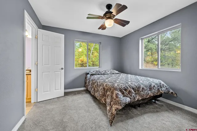 a bedroom with a bed a window and a chandelier