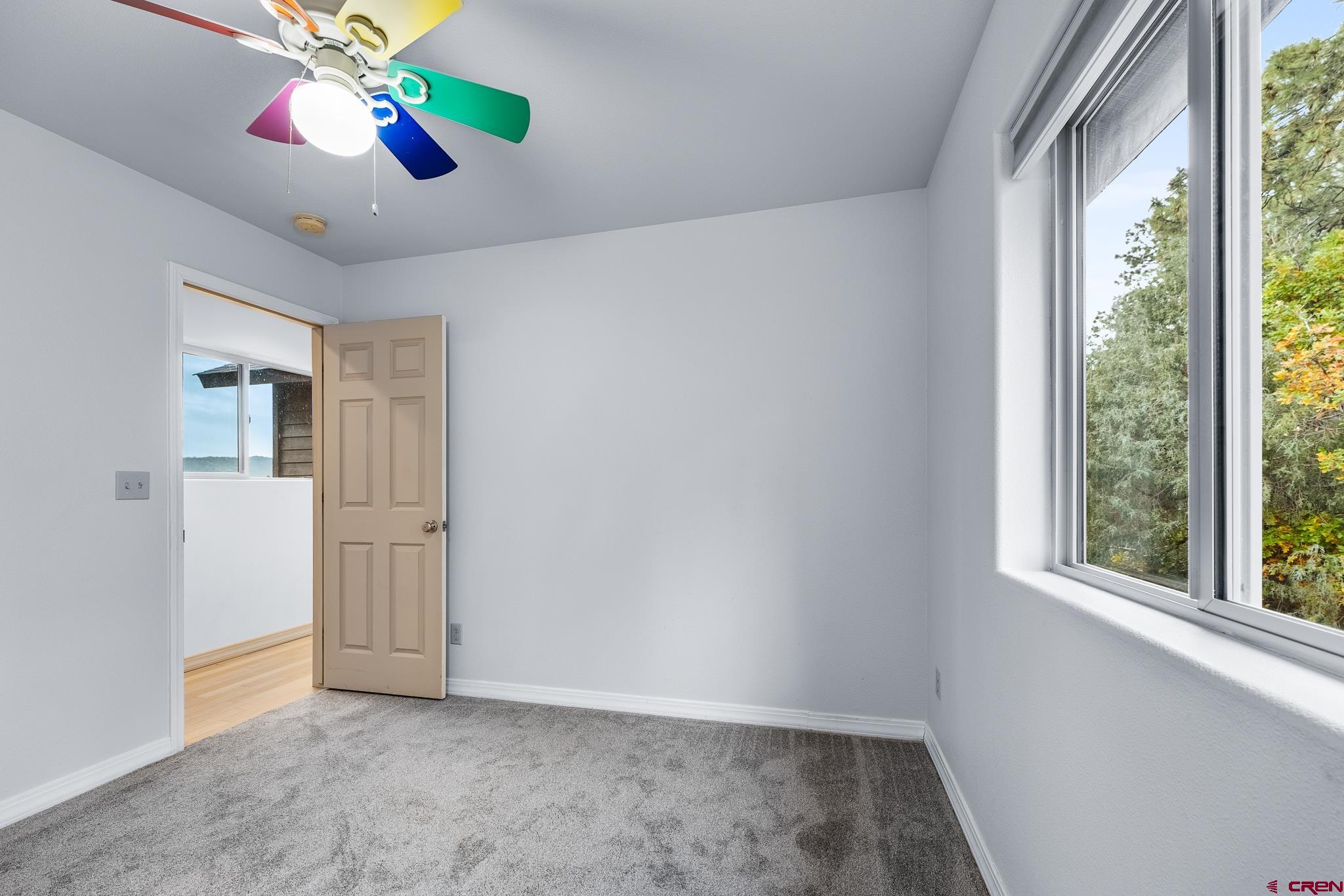 199 Logging Trail Road Durango, CO 81303 - Photo 28 of 33 a view of an empty room with window and chandelier fan