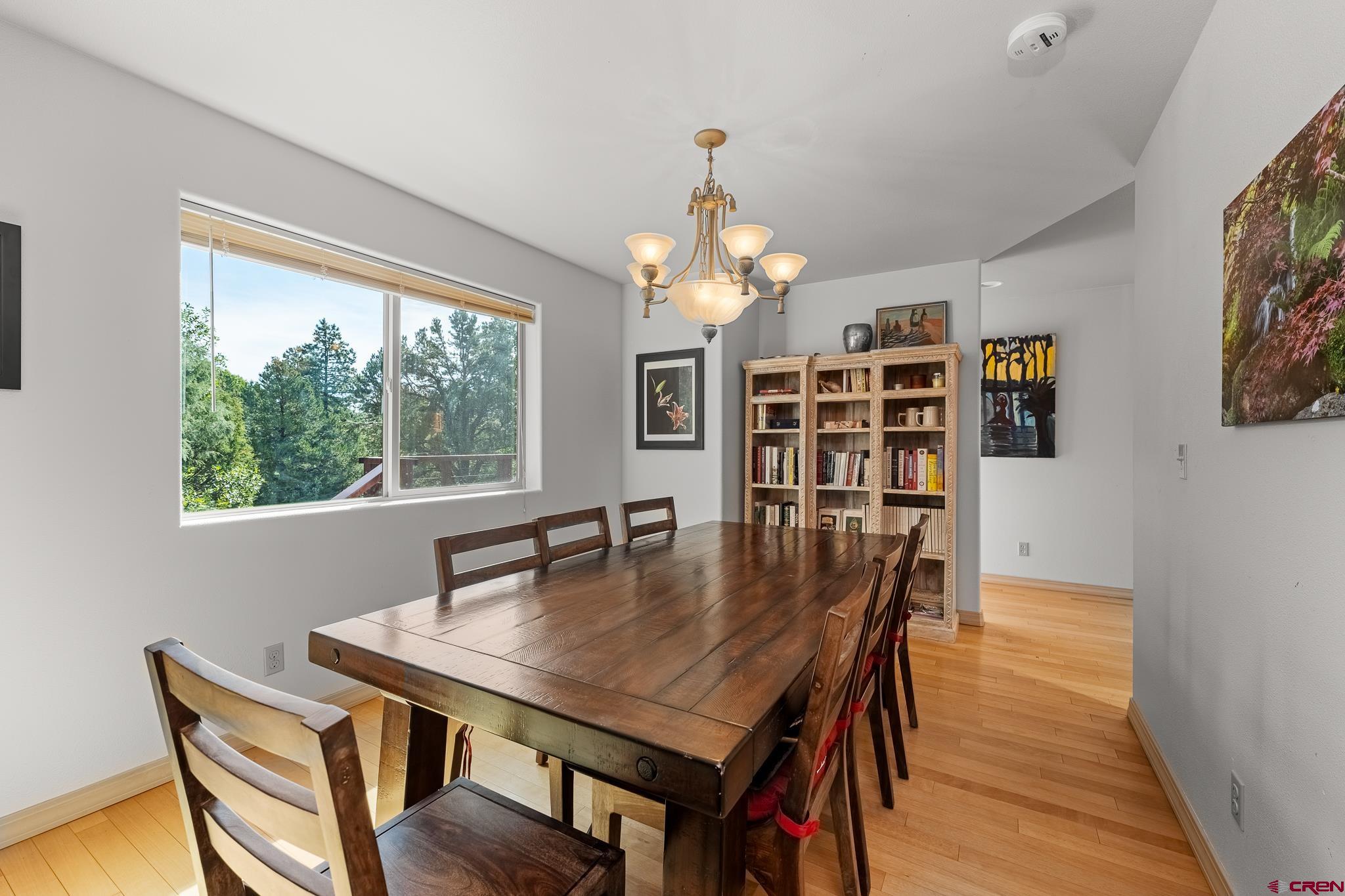 199 Logging Trail Road Durango, CO 81303 - Photo 6 of 33 a view of a dining room with furniture window and wooden floor