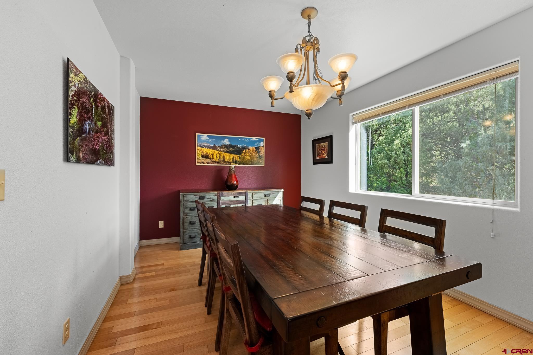 199 Logging Trail Road Durango, CO 81303 - Photo 7 of 33 a view of a dining room with furniture a chandelier and wooden floor