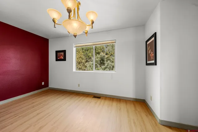a view of room with window and wooden floor