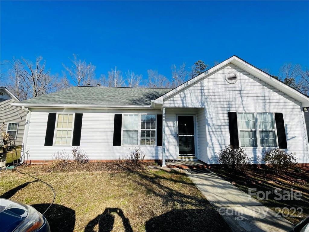 a view of a house with large windows and a table and chairs