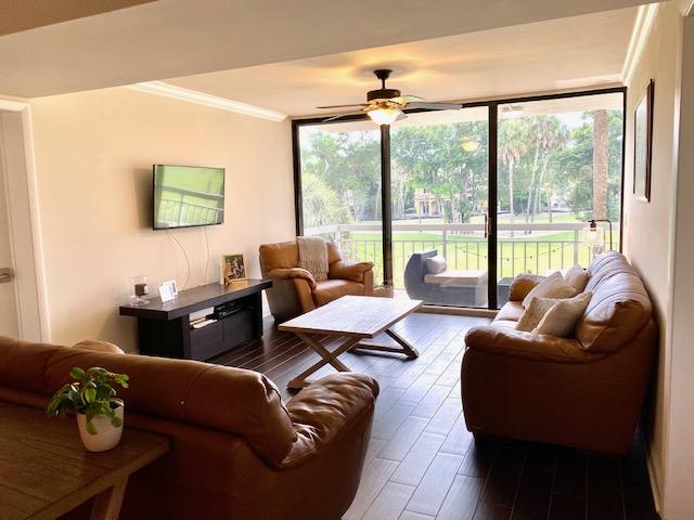 6181 Balboa Circle, Unit 205 Boca Raton, FL 33433 - Photo 1 of 27 a living room with furniture and floor to ceiling windows