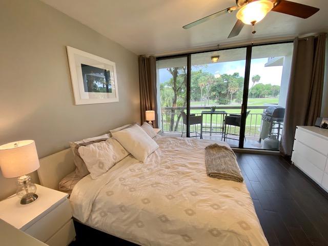 6181 Balboa Circle, Unit 205 Boca Raton, FL 33433 - Photo 11 of 27 a bedroom with a bed and a large window