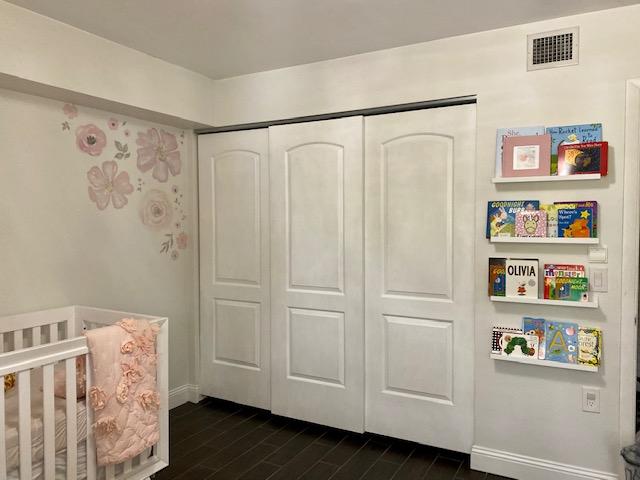 6181 Balboa Circle, Unit 205 Boca Raton, FL 33433 - Photo 18 of 27 a view of a bedroom with wooden floor and closet