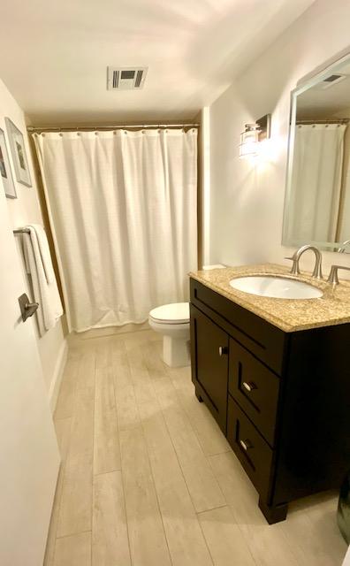 6181 Balboa Circle, Unit 205 Boca Raton, FL 33433 - Photo 20 of 27 a bathroom with a granite countertop sink and a mirror