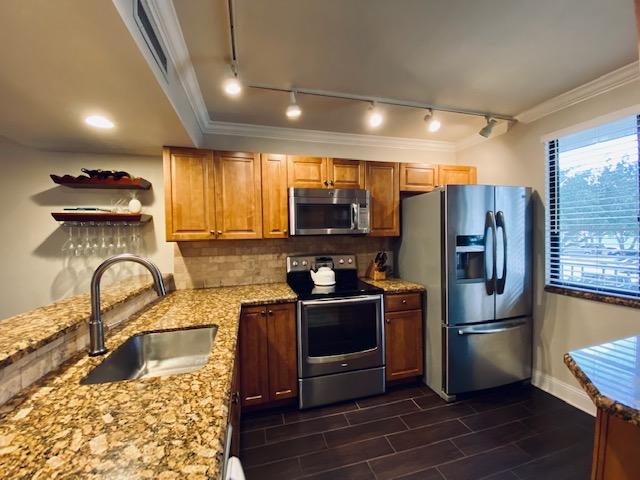 6181 Balboa Circle, Unit 205 Boca Raton, FL 33433 - Photo 2 of 27 a kitchen with stainless steel appliances granite countertop a refrigerator a stove a sink and a microwave