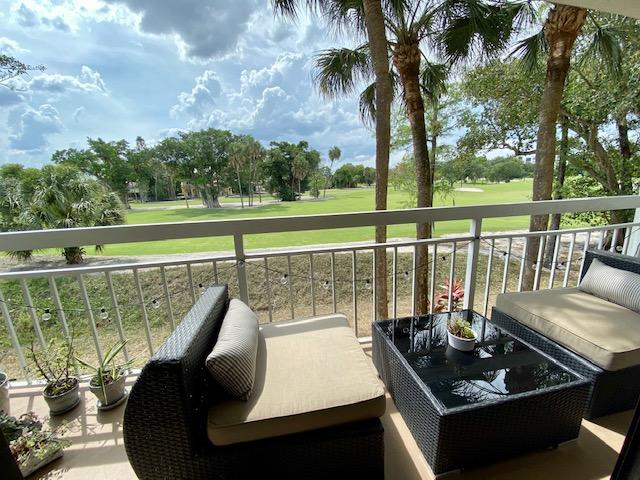 6181 Balboa Circle, Unit 205 Boca Raton, FL 33433 - Photo 26 of 27 a view of a balcony with mountain view and wooden floor