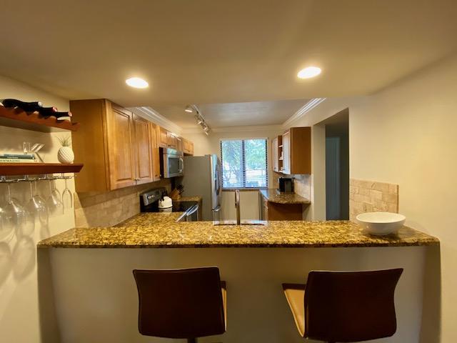 6181 Balboa Circle, Unit 205 Boca Raton, FL 33433 - Photo 4 of 27 a bathroom with a granite countertop sink and a mirror