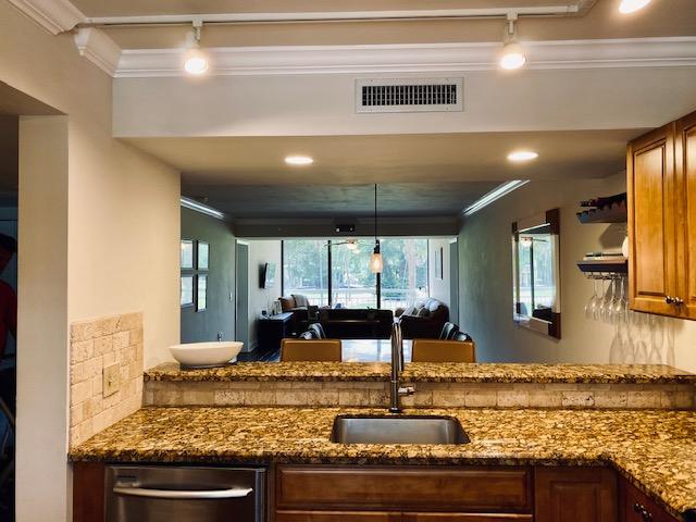 6181 Balboa Circle, Unit 205 Boca Raton, FL 33433 - Photo 5 of 27 a view of a kitchen with kitchen island a large window cabinets and stainless steel appliances