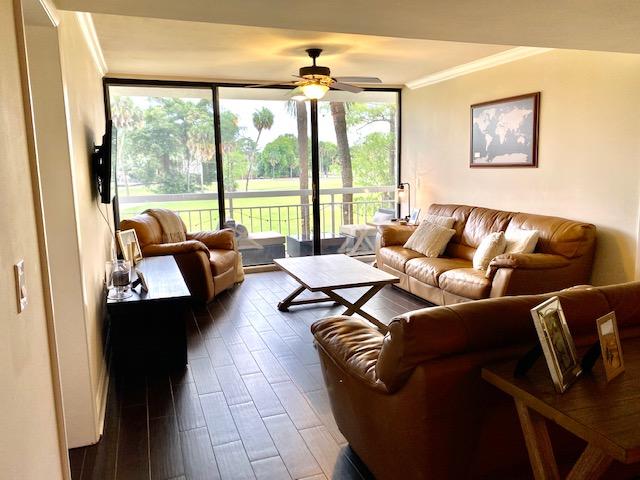 6181 Balboa Circle, Unit 205 Boca Raton, FL 33433 - Photo 8 of 27 a living room with furniture and a floor to ceiling window