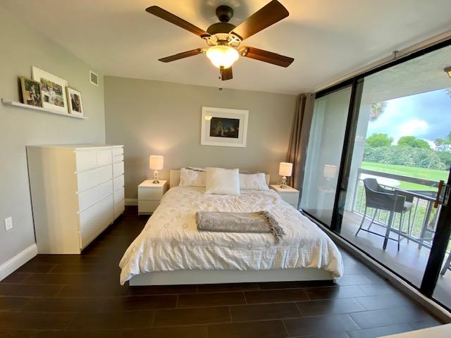 6181 Balboa Circle, Unit 205 Boca Raton, FL 33433 - Photo 9 of 27 a bedroom with a bed and a large window