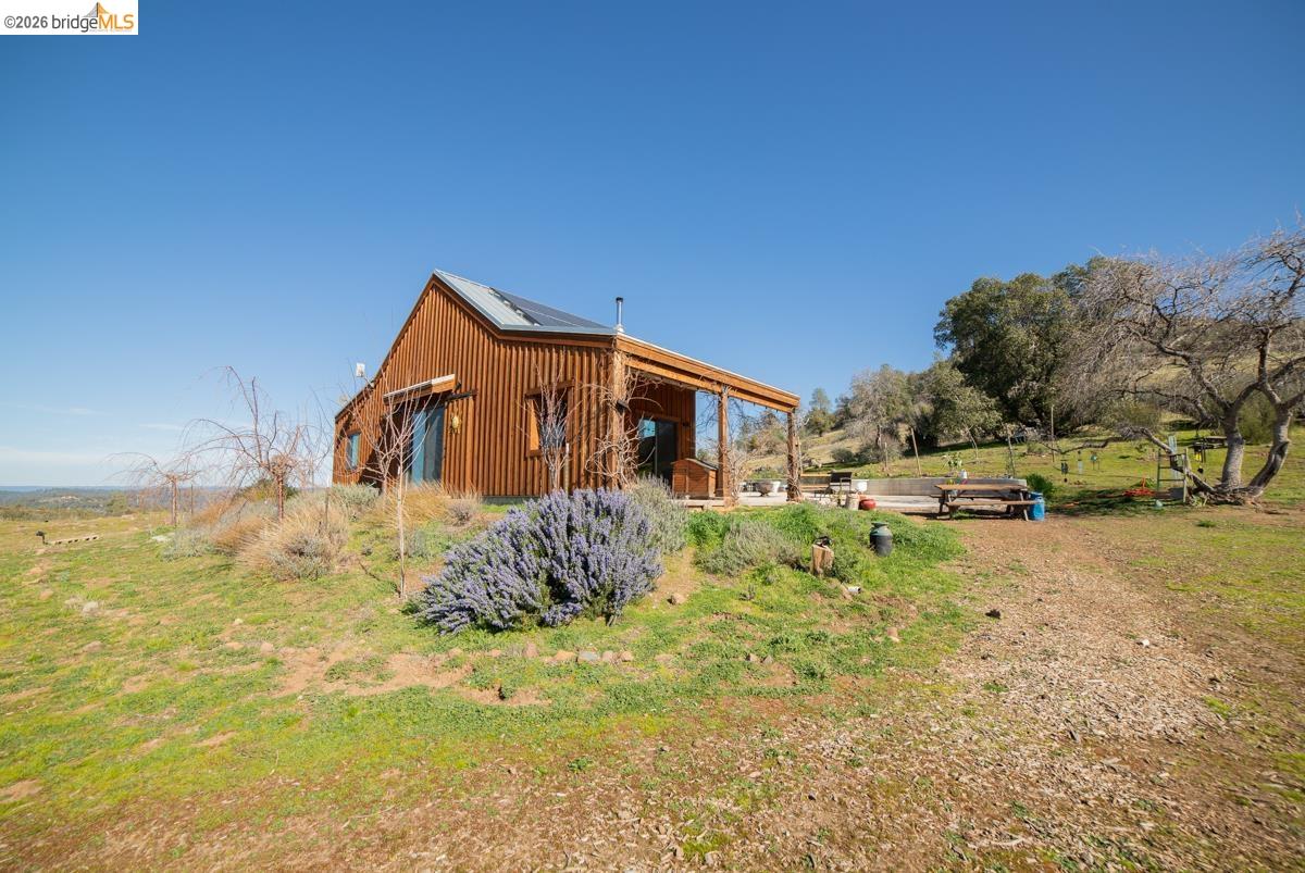 6899 Eagle View Drive Mountain Ranch, CA 95246 - Photo 11 of 35 a backyard of a house with large trees