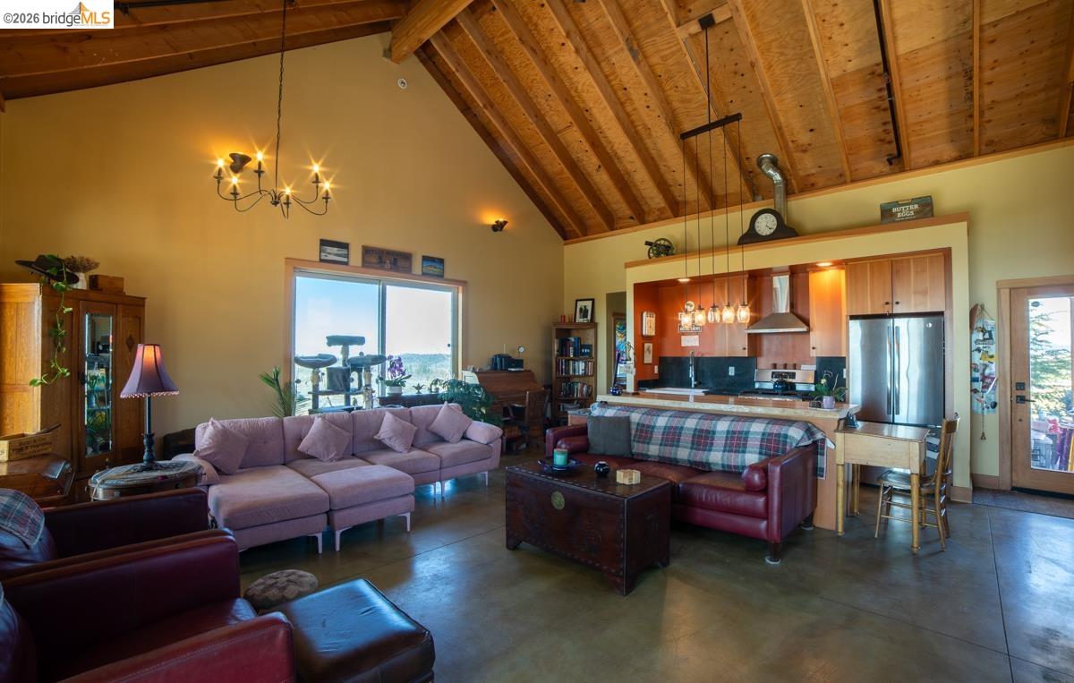 6899 Eagle View Drive Mountain Ranch, CA 95246 - Photo 15 of 35 a living room with furniture and a chandelier