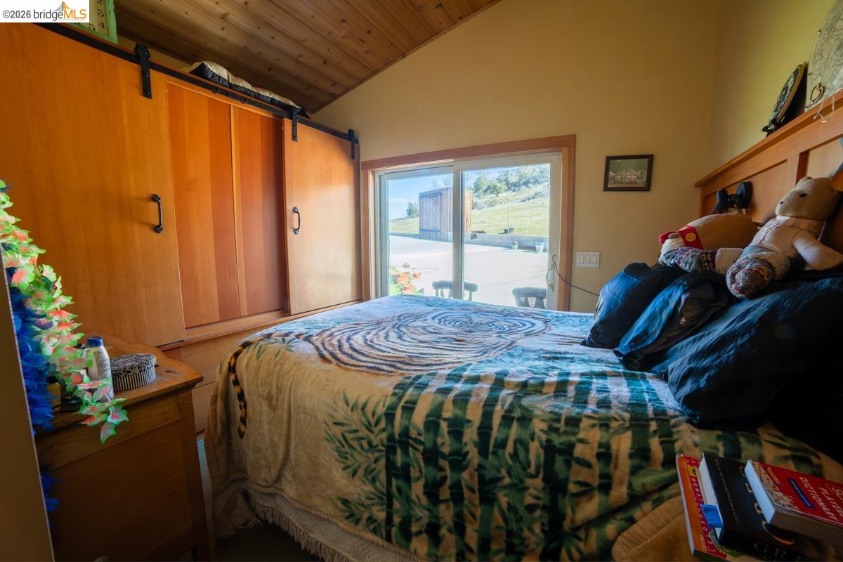 6899 Eagle View Drive Mountain Ranch, CA 95246 - Photo 23 of 35 a bed sitting in a bedroom next to a window