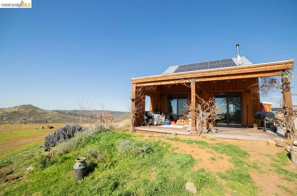 a view of a house with outdoor space and sitting area