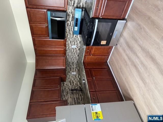 a kitchen with stainless steel appliances granite countertop wooden cabinets a stove top oven a sink and dishwasher