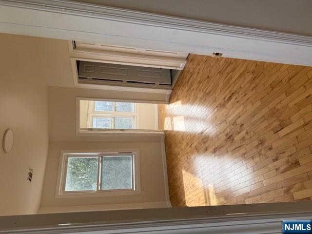 611 South 19th Street, Unit 2 Newark, NJ 07103 - Photo 5 of 8 a view of an empty room with wooden floor and a window