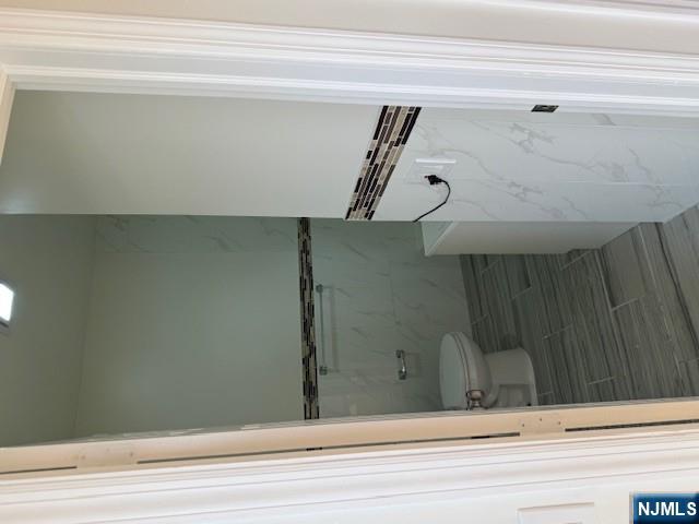 611 South 19th Street, Unit 2 Newark, NJ 07103 - Photo 6 of 8 a bathroom with a granite countertop shower and a toilet