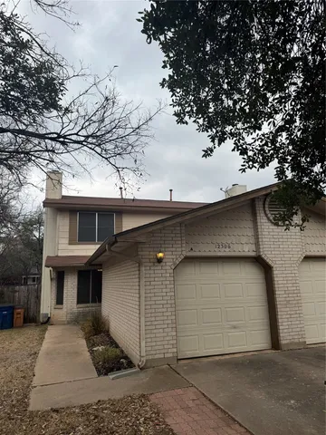 a front view of a house with garage