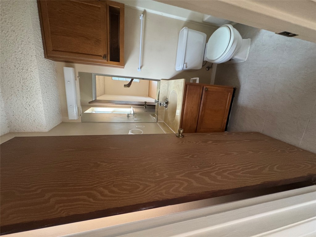 12306 Cahone Trail, Unit A Austin, TX 78729 - Photo 20 of 25 a bathroom with a sink toilet and mirror