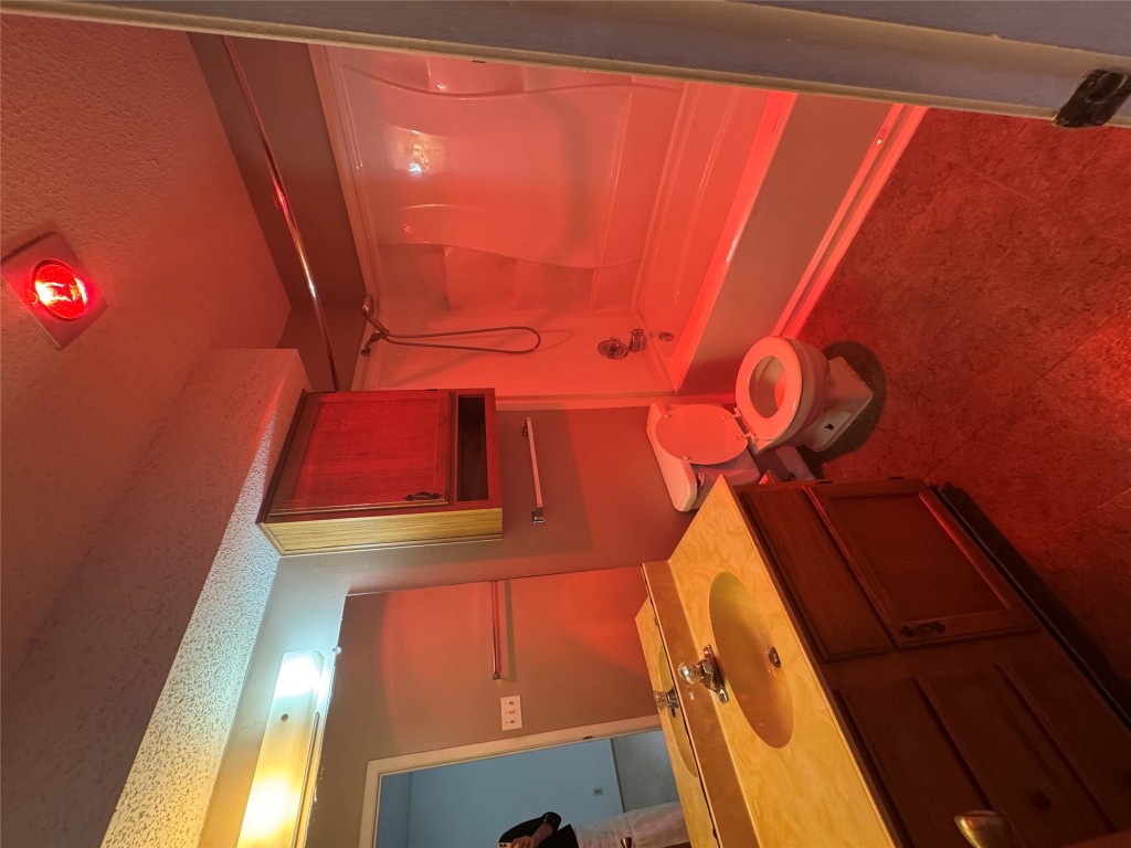 12306 Cahone Trail, Unit A Austin, TX 78729 - Photo 24 of 25 a bathroom with a sink mirror vanity and toilet