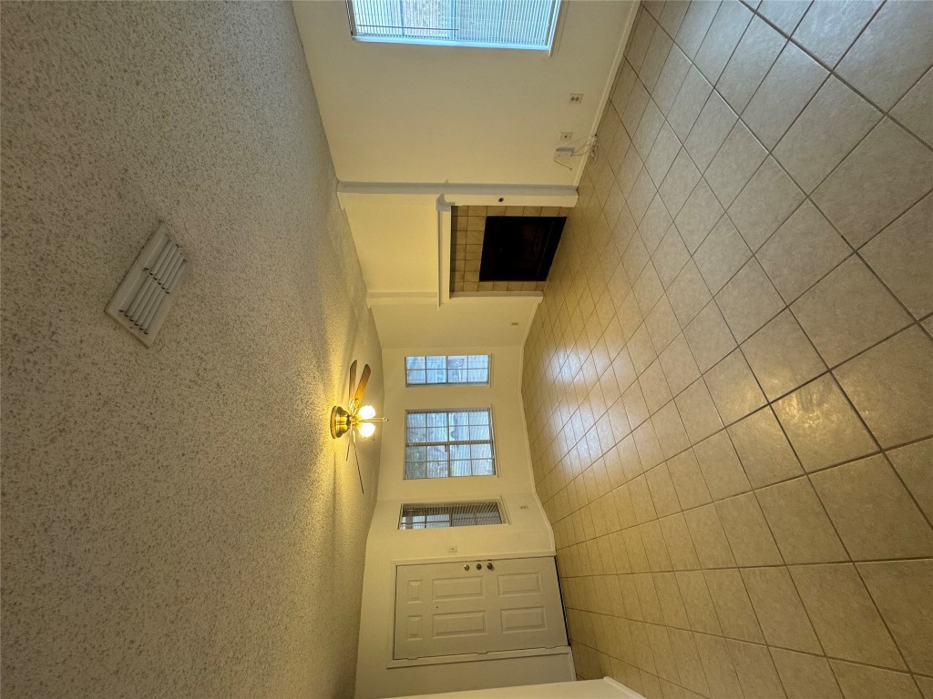 12306 Cahone Trail, Unit A Austin, TX 78729 - Photo 6 of 25 an empty room with windows and fireplace