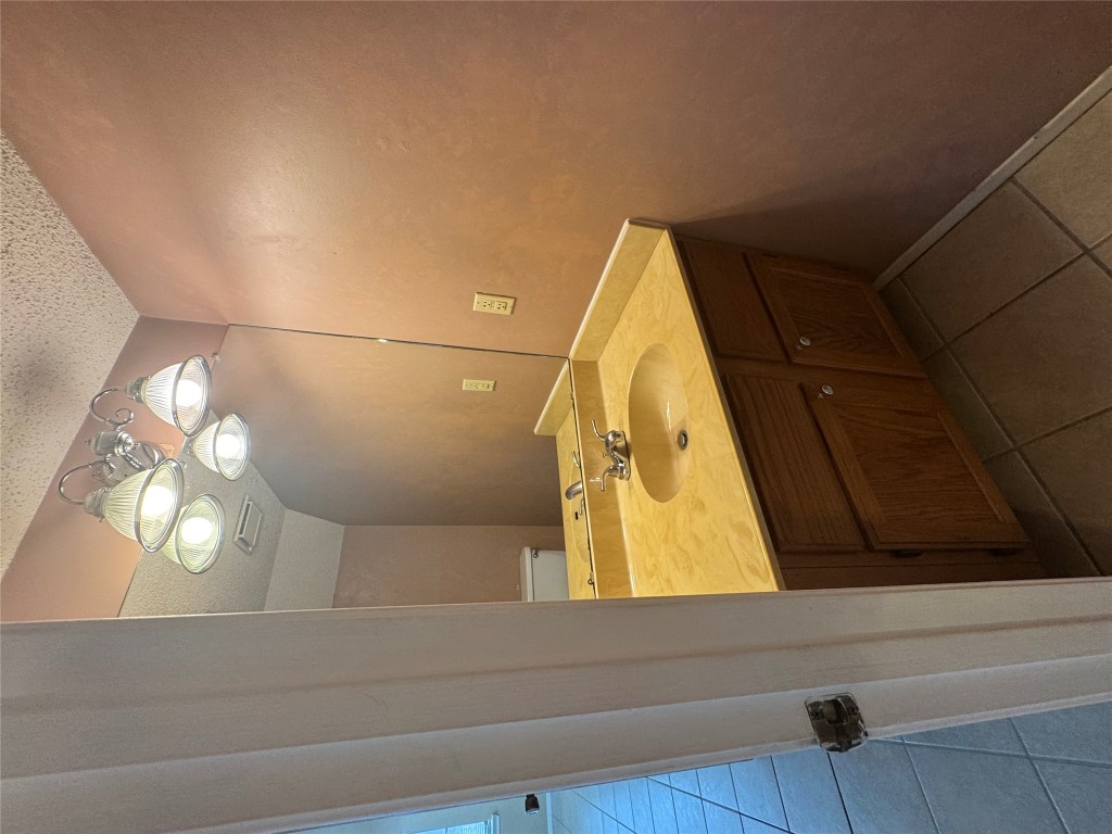 12306 Cahone Trail, Unit A Austin, TX 78729 - Photo 7 of 25 a bathroom with a sink and a mirror