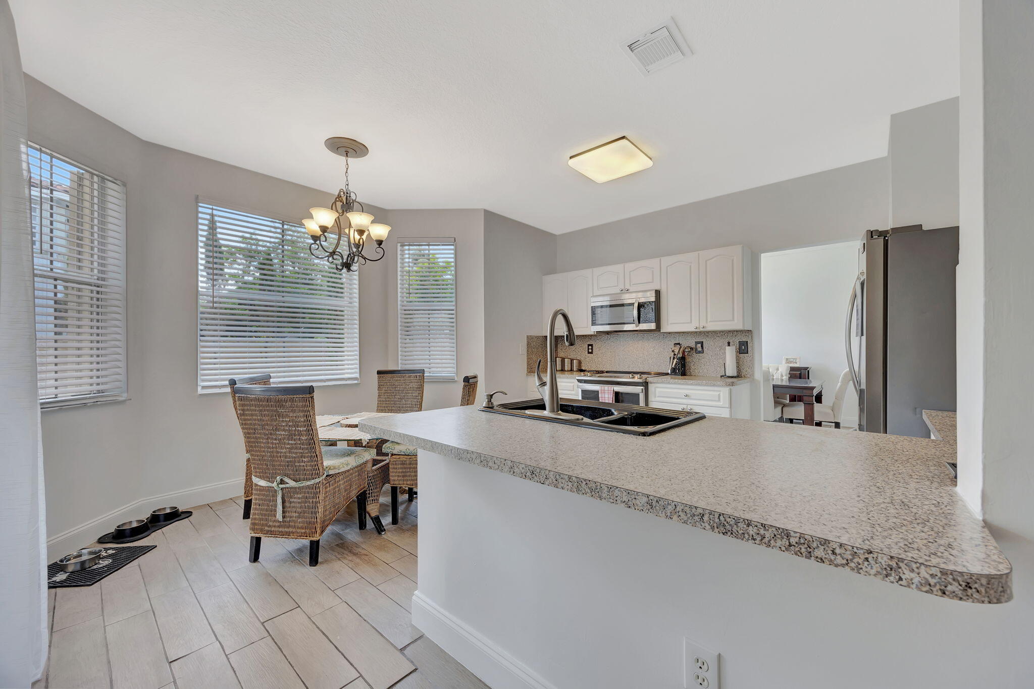 13838 Southwest 41st Terrace Miami, FL 33175 - Photo 17 of 68 a kitchen with kitchen island granite countertop a sink cabinets and window