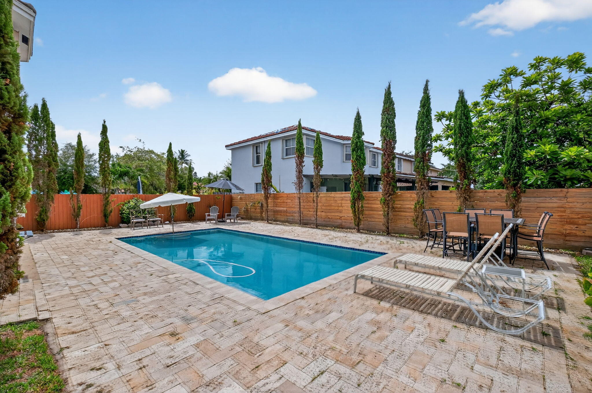 13838 Southwest 41st Terrace Miami, FL 33175 - Photo 55 of 68 a view of a swimming pool with a lounge chairs