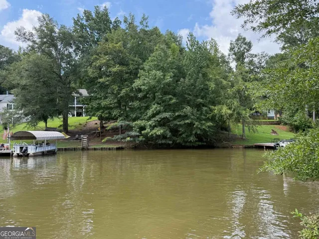 a view of a lake with houses in the background