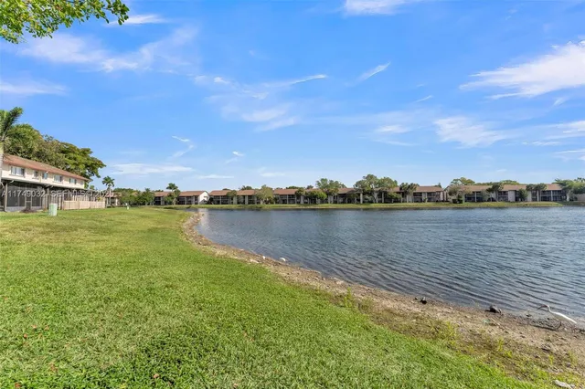 a view of a lake with houses in the background