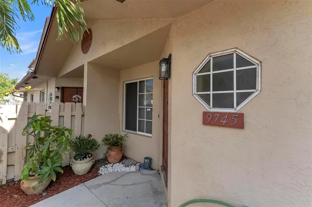 a room with potted plants and a table