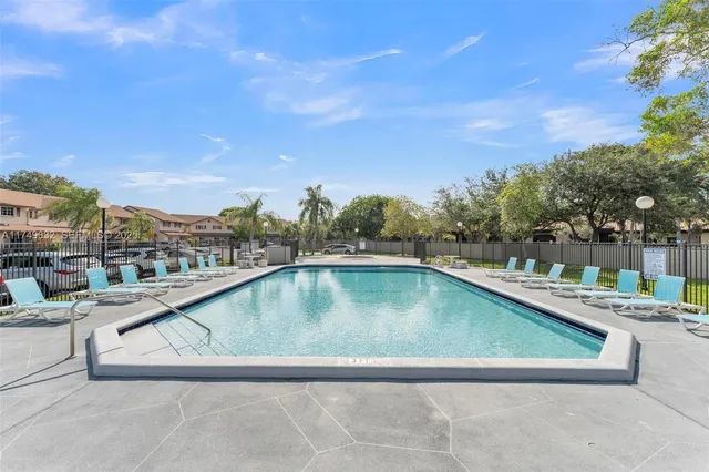 a view of swimming pool with outdoor seating and plants