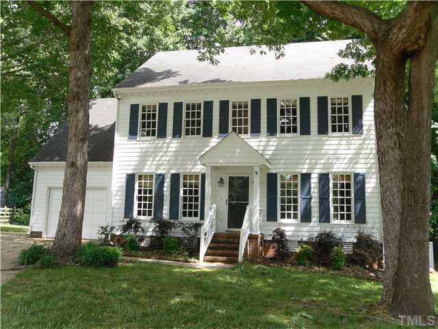 a front view of a house with a yard and porch