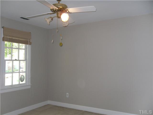 8716 Master Court Raleigh, NC 27615 - Photo 11 of 15 an empty room with a window and a fan