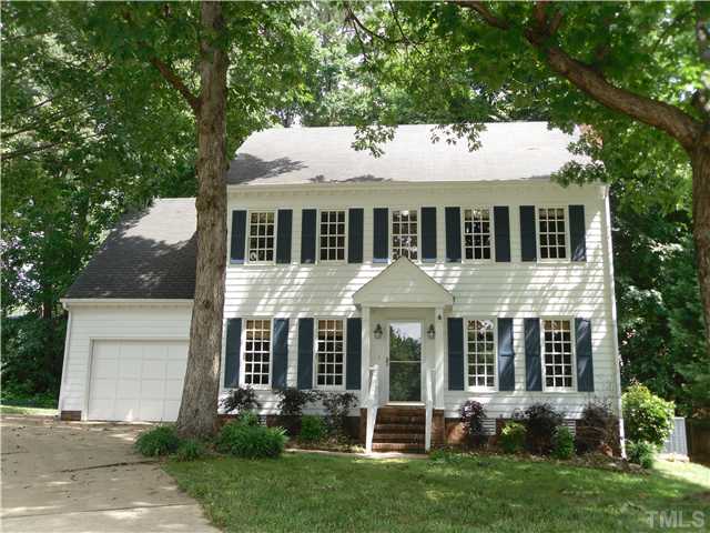 8716 Master Court Raleigh, NC 27615 - Photo 2 of 15 a front view of a house with a yard and trees