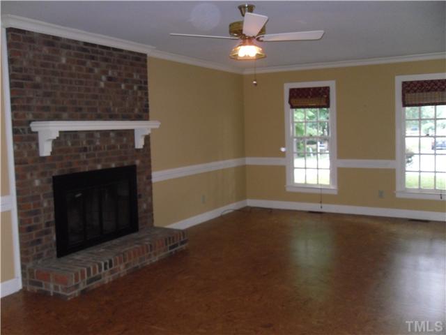 8716 Master Court Raleigh, NC 27615 - Photo 5 of 15 a view of an empty room with wooden floor fireplace and a window