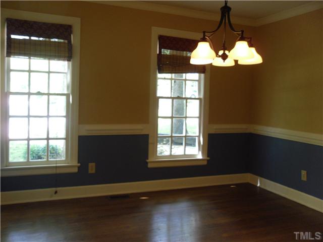 8716 Master Court Raleigh, NC 27615 - Photo 7 of 15 a view of an empty room with wooden floor and a window